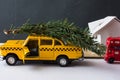 Yellow toy taxi on a tree trunk. Royalty Free Stock Photo