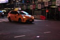 Yellow Toyota Prius Taxi driving at Timesquare in New York, USA
