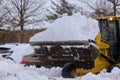 The yellow tractor cleans road in the snow Royalty Free Stock Photo