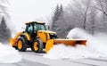 Yellow tractor cleans up snow from the road. Cleaning and removal of roads in the city from snow in winter after snowfall.