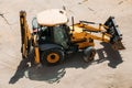 Yellow tractor on the construction site on a sunny day view from above