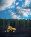 Yellow tractor on dark field Royalty Free Stock Photo