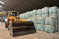 Yellow tractor in rice mill Royalty Free Stock Photo