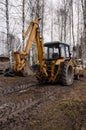 yellow tractor among trees in open air on farm without driver. Rear view. Agricultural machinery. Development of agriculture.