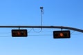 Yellow traffic light with camera Royalty Free Stock Photo