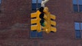 A yellow traffic light hangs at intersection in New York, USA. Red stop signal. Royalty Free Stock Photo