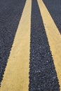 Yellow traffic lines marking on asphalt road