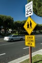 Yellow traffic sign that says Senior Citizens Area with graphic of senior citizens walking along