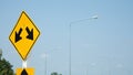 Yellow traffic signs with two white arrow heads indicate the intersection on the road, on blue sky as the background, indicates Royalty Free Stock Photo