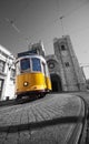 Yellow tram on the background of Lisbon Cathedral