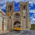 Yellow Tram and Lisbon Cathedral of St. Mary Major Se de Lisboa in Lisbon, Portugal Royalty Free Stock Photo