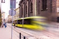 Yellow tram with motion blur effect moves fast in the city. High speed passenger train in motion on railroad. Modern urban rail Royalty Free Stock Photo