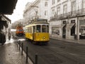 Yellow Tram and Vehicle circulating in Lisbon, Portugal