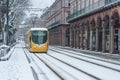 Yellow Tramway rolling in the snowy streets