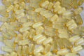 Yellow transparent oval omega-3 capsules on a wooden surface