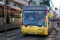 Yellow Transport for Greater Manchester bus on a busy street in city centre