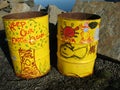 Yellow trash barrels with environmental graffiti Royalty Free Stock Photo