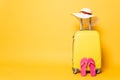 Yellow travel bag with flip flops