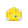 Yellow travel bag suitcase with stickers. Royalty Free Stock Photo