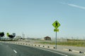 Yellow triangle with a pedestrian street sign on the winding asphalt road. Royalty Free Stock Photo