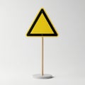 Yellow triangle warning sign on a pole against a light background Royalty Free Stock Photo