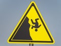 Yellow triangular hazard warning sign on a gray background