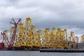 Tripods for supporting wind turbines awaiting relocation in the North Sea, photographed at port in Cromarty, Scotland UK. Royalty Free Stock Photo