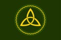 Yellow triquetra, celtic triangle knot, in circle frame, over green