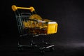 Yellow trolley full of golden bitcoin with black background, Digital busniess and finance concept Royalty Free Stock Photo