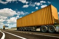 Yellow truck and container is on highway - business, commercial, cargo transportation concept, clear and blank space on the side Royalty Free Stock Photo