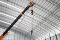 Yellow truck crane boom with hooks in the warehouse. Royalty Free Stock Photo