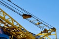 Yellow truck crane on the street. Slings in the frame. Close-up. Daylight. There is a tint