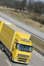 Yellow truck-driving, close-up Royalty Free Stock Photo