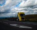 Yellow truck parked on side of the road