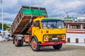 Yellow truck unloading cargo