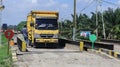 the yellow truck is on the weighbridge of the palm oil processing plant