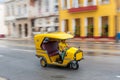 HAVANA, CUBA - OCTOBER 21, 2017: Yellow Tuk Tuk Taxi Vehicle in Havana, Cuba. Woman is Driver Royalty Free Stock Photo
