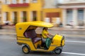 HAVANA, CUBA - OCTOBER 21, 2017: Yellow Tuk Tuk Taxi Vehicle in Havana, Cuba. Woman is Driver Royalty Free Stock Photo