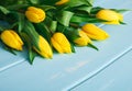 Yellow tulips on blue wood background, copy space Royalty Free Stock Photo