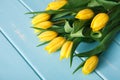 Yellow tulips on blue wood background, copy space Royalty Free Stock Photo