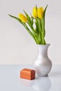 Yellow tulips bouquet with gift box on a table in vase Royalty Free Stock Photo