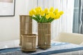 Yellow tulips in copper vase