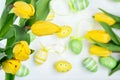 Yellow tulips and easter eggs on white wooden table, top view (selective focus Royalty Free Stock Photo