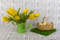 Yellow tulips in green watering can