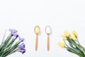 Yellow tulips, purple irises and a pair of spoon with Easter egg