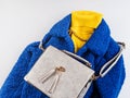 Yellow turtle neck with gray handbag, blue coat Royalty Free Stock Photo