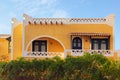 Yellow two-storey hotel building in the Arabic style. Tourist resort near the Red Sea. Summer vacation concept. Royalty Free Stock Photo