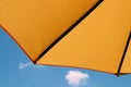 Yellow umbrella in a blue sky Royalty Free Stock Photo