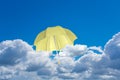 A yellow umbrella flies above the clouds.