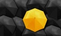 Yellow umbrella standing out from background of black umbrellas. Royalty Free Stock Photo